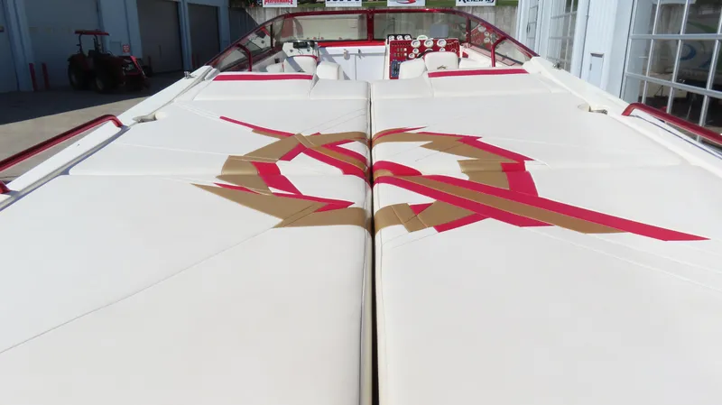 Slide: The Image of 2002 Fountain 47 Lightning boat with distinctive red and gold design on white upholstery. - 41