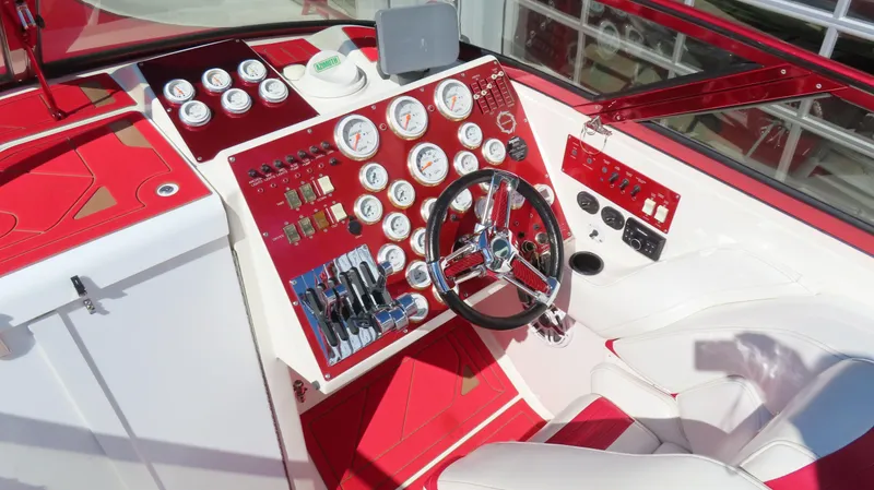 Slide: The Image of 2002 Fountain 47 Lightning boat dashboard with red and white design, featuring multiple gauges and controls. - 5