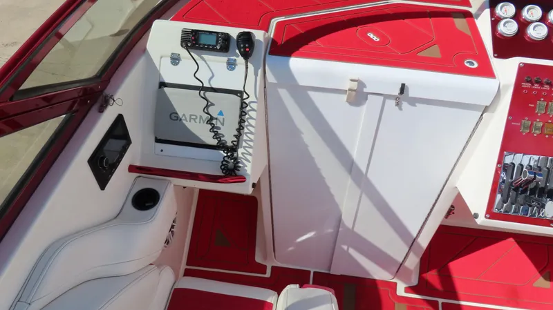 Slide: The Image of Interior of 2002 Fountain 47 Lightning boat with red and white design, featuring Garmin equipment. - 6