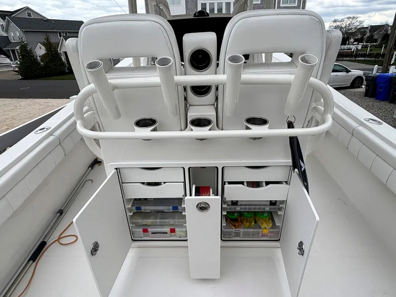 Slide: The Image of 2018 Regulator 28 boat with open storage compartments and rod holders. - 18