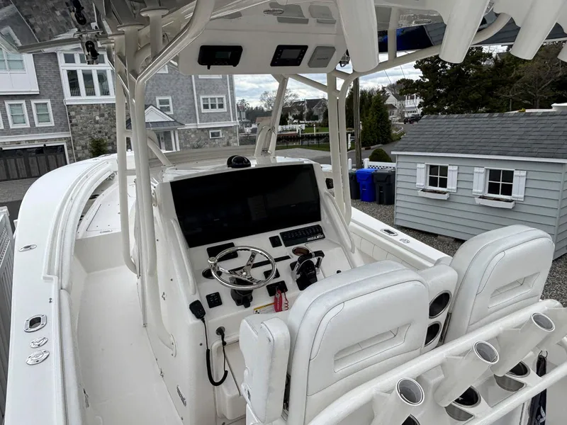 Slide: The Image of 2018 Regulator 28 boat cockpit with dual seats and modern controls. - 4