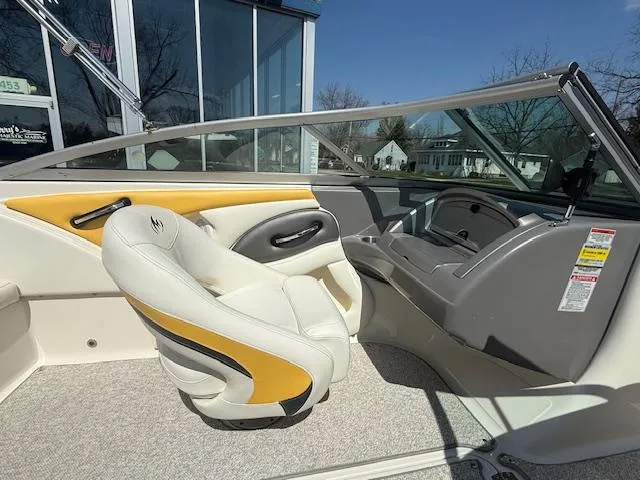 Slide: The Image of 2008 Monterey 194FS boat interior with white and yellow seating, under clear blue sky. - 11