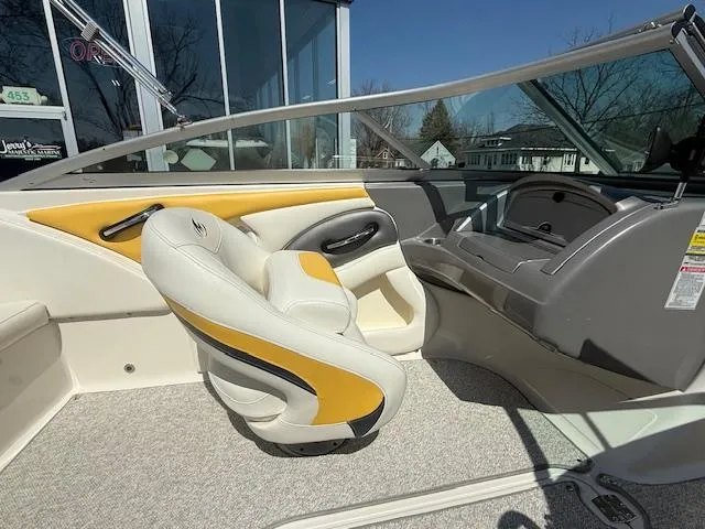 Slide: The Image of Interior of a 2008 Monterey 194FS boat with yellow and white seating. - 12
