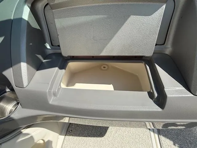 Slide: The Image of Storage compartment in a 2008 Monterey 194FS boat, featuring a sleek gray design. - 14