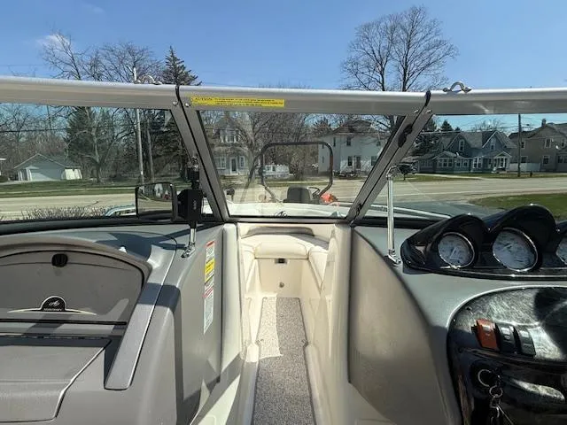 Slide: The Image of Interior view of a 2008 Monterey 194FS boat, showcasing dashboard and seating area. - 16
