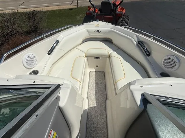 Slide: The Image of 2008 Monterey 194FS boat interior with seating and speakers, viewed from the bow. - 18