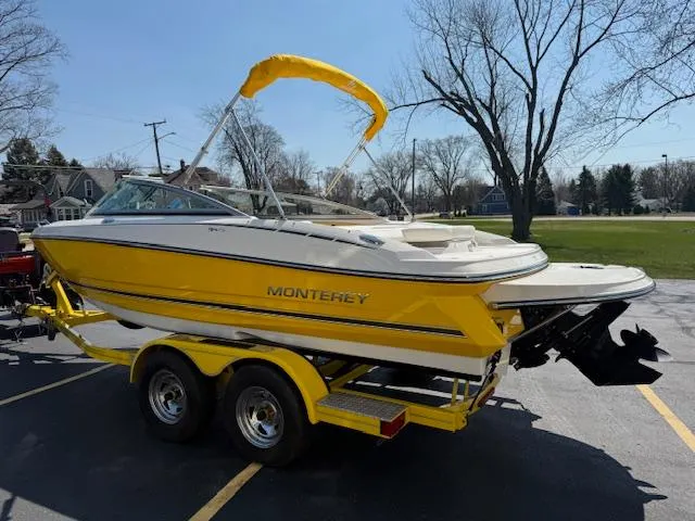 Slide: The Image of Yellow 2008 Monterey 194FS boat on trailer in sunny outdoor setting. - 2