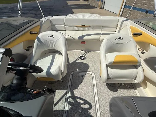 Slide: The Image of Interior of a 2008 Monterey 194FS boat with white and yellow seating. - 23