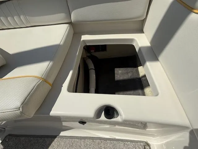 Slide: The Image of 2008 Monterey 194FS boat interior storage compartment with cushioned seating. - 24