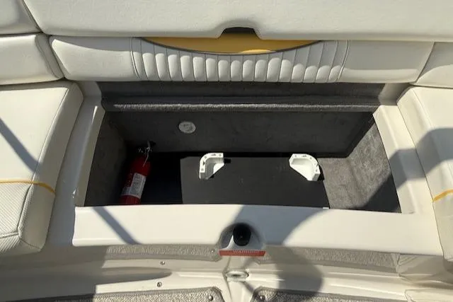 Slide: The Image of Storage compartment in a 2008 Monterey 194FS boat, featuring a fire extinguisher. - 26