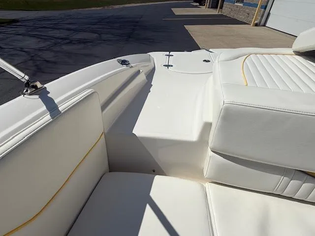 Slide: The Image of 2008 Monterey 194FS boat interior with white cushioned seating and yellow accents. - 27