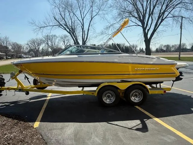 Slide: The Image of Yellow 2008 Monterey 194FS boat on trailer in parking lot. - 3