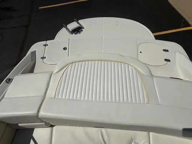 Slide: The Image of 2008 Monterey 194FS boat interior with white cushioned seating and storage compartments. - 32