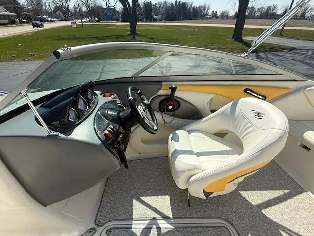 Slide: The Image of 2008 Monterey 194FS boat interior with steering wheel and white captain's chair. - 7