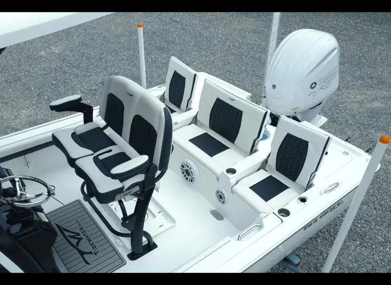 Slide: The Image of 2025 Tidewater 2500 Carolina Bay boat interior with seating and motor. - 12
