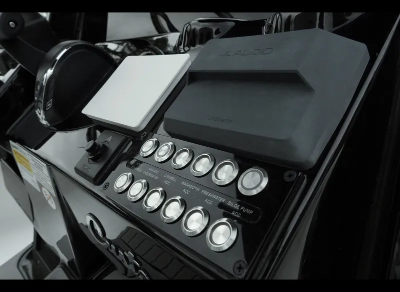 Slide: The Image of Control panel of 2025 Tidewater 2500 Carolina Bay boat with buttons and switches. - 16