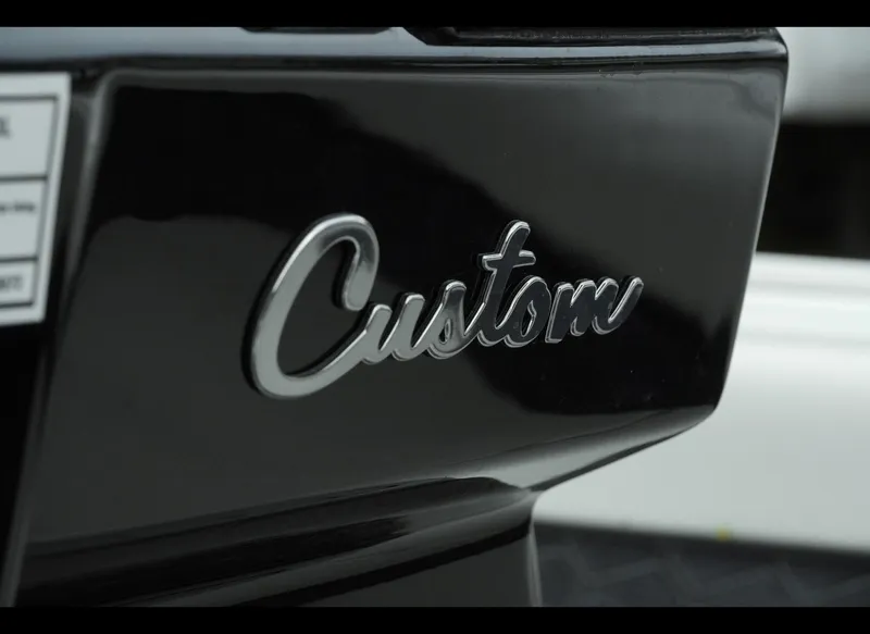 Slide: The Image of Close-up of 'Custom' emblem on 2025 Tidewater 2500 Carolina Bay boat. - 17