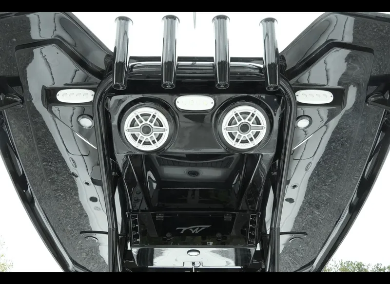 Slide: The Image of 2025 Tidewater 2500 Carolina Bay boat, featuring sleek black design and modern audio system. - 19