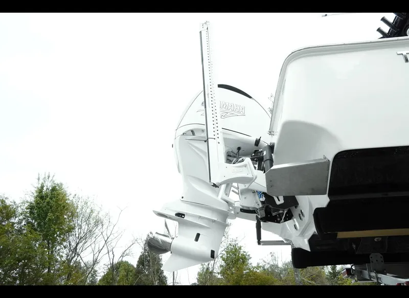 Slide: The Image of 2025 Tidewater 2500 Carolina Bay boat with outboard motor, viewed from the rear. - 5