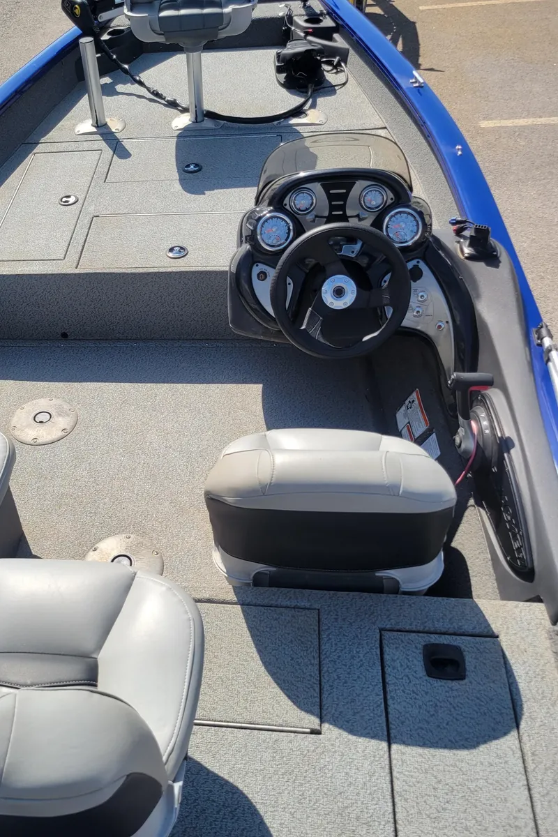 Slide: The Image of 2018 Tracker Pro Team 175TF boat interior with steering console and seating. - 2