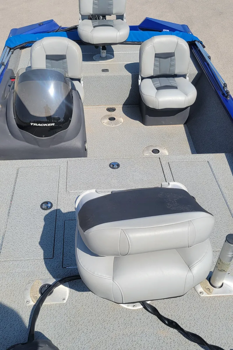 Slide: The Image of 2018 Tracker Pro Team 175TF boat interior with gray seating and steering console. - 3
