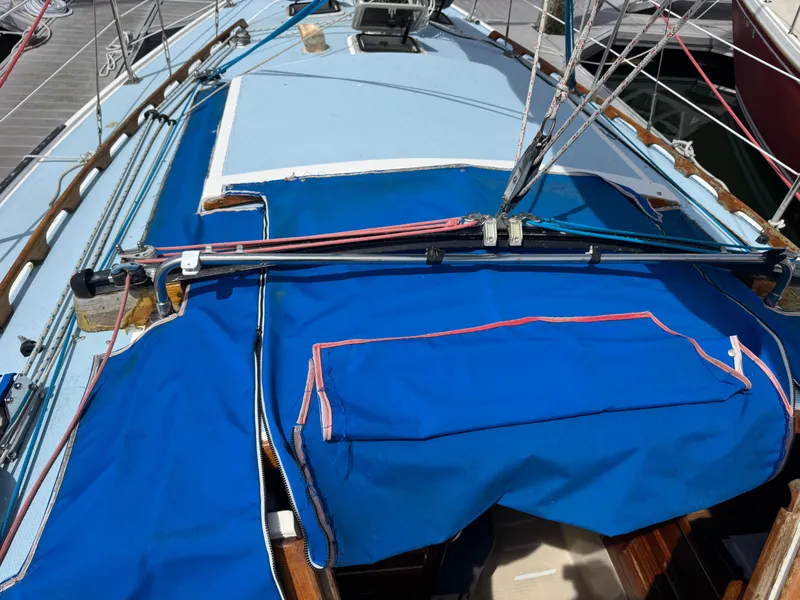 Slide: The Image of 1985 Catalina 30 sailboat deck with blue canvas cover and rigging. - 18