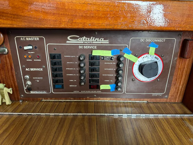 Slide: The Image of Electrical panel of a 1985 Catalina 30 yacht with AC and DC service controls. - 22