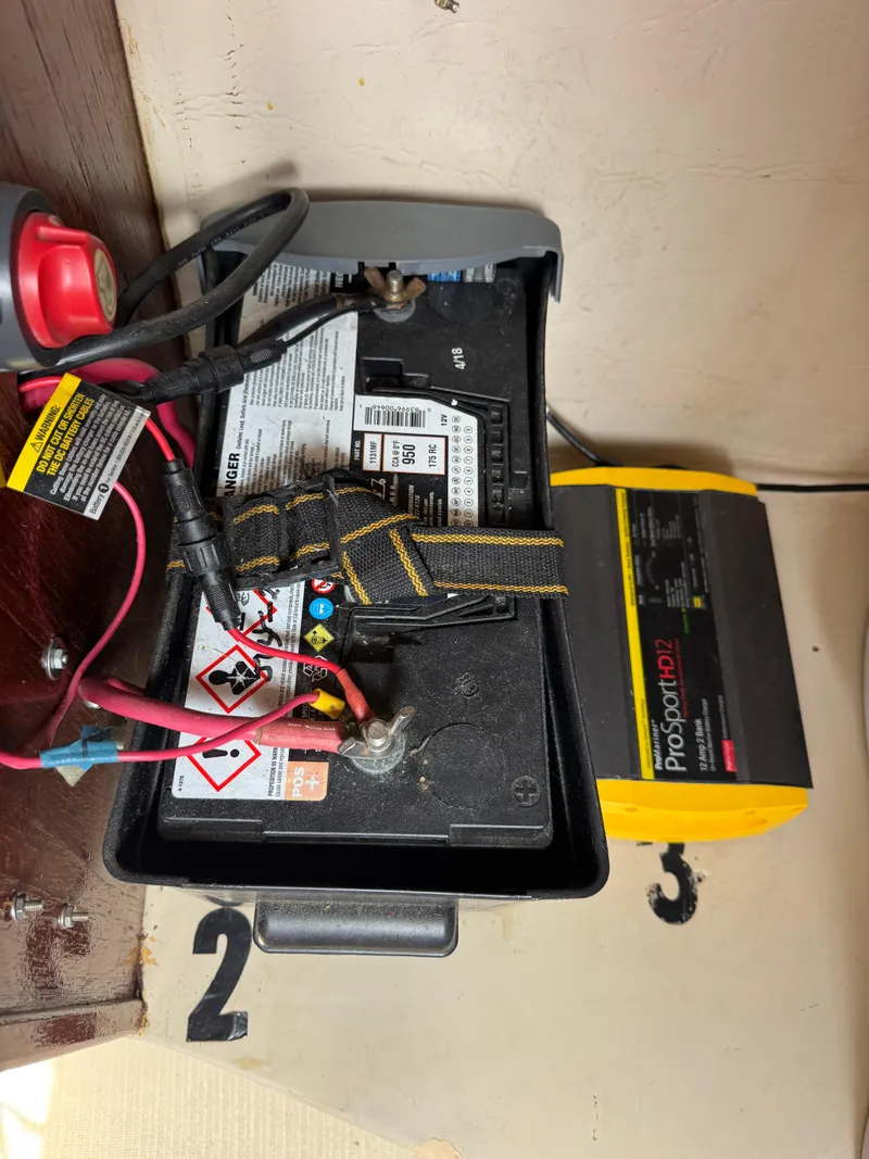 Slide: The Image of Battery setup in a 1985 Catalina 30 sailboat with charger and wiring. - 23