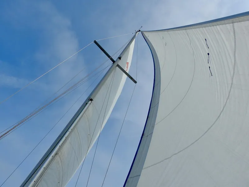 Slide: The Image of Sails of a 1985 Catalina 30 yacht against a clear blue sky. - 30