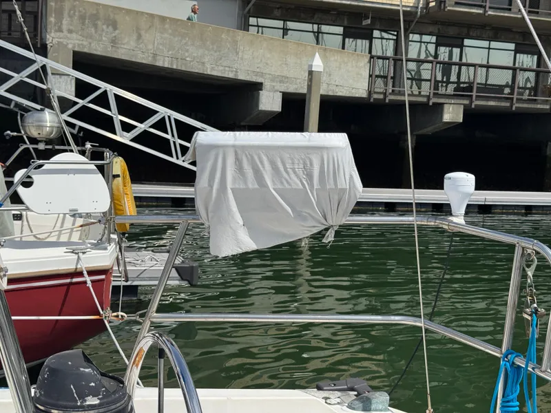 Slide: The Image of Catalina 30 sailboat docked in marina, covered equipment, 1985 model. - 33