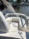 Slide: The Image of 2005 Sea Ray 320 Sundancer boat with striped seating, docked by the water. - 17