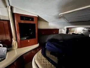 Slide: The Image of Interior cabin of 2005 Sea Ray 320 Sundancer with wood cabinetry and seating area. - 18