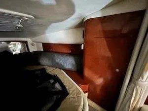Slide: The Image of Interior cabin of 2005 Sea Ray 320 Sundancer with wood paneling and bedding. - 20
