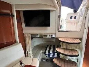 Slide: The Image of Interior of 2005 Sea Ray 320 Sundancer with TV, seating, and wooden steps. - 21