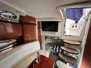 Slide: The Image of Interior of 2005 Sea Ray 320 Sundancer with wooden cabinetry and seating area. - 22