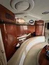 Slide: The Image of Interior of 2005 Sea Ray 320 Sundancer with elegant wood cabinetry and curved seating. - 24
