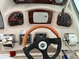 Slide: The Image of Control panel of a 2005 Sea Ray 320 Sundancer boat with steering wheel and gauges. - 7