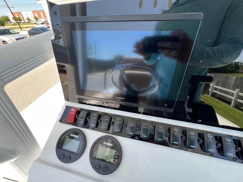 Slide: The Image of 2025 Sea Hunt BX22BR boat dashboard with digital display and control panel. - 18