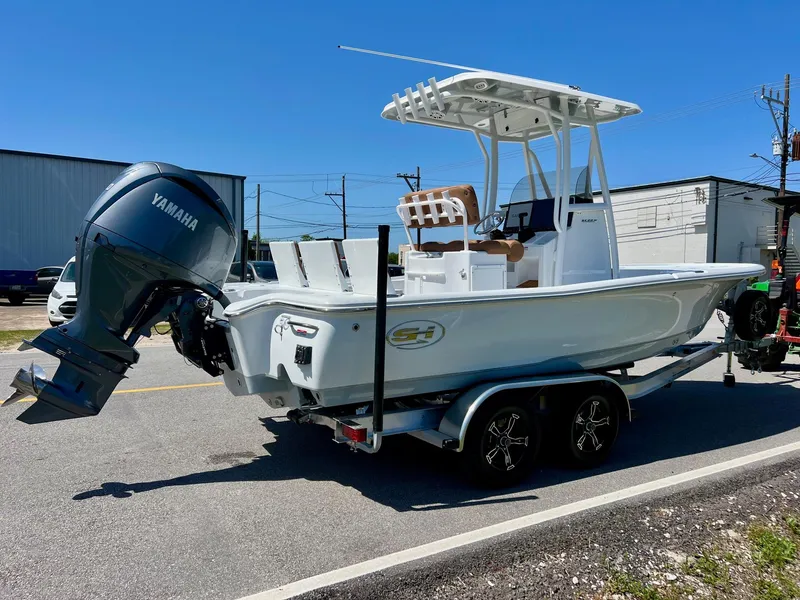 Slide: The Image of 2025 Sea Hunt BX22BR boat on trailer with Yamaha outboard motor, parked outdoors. - 4