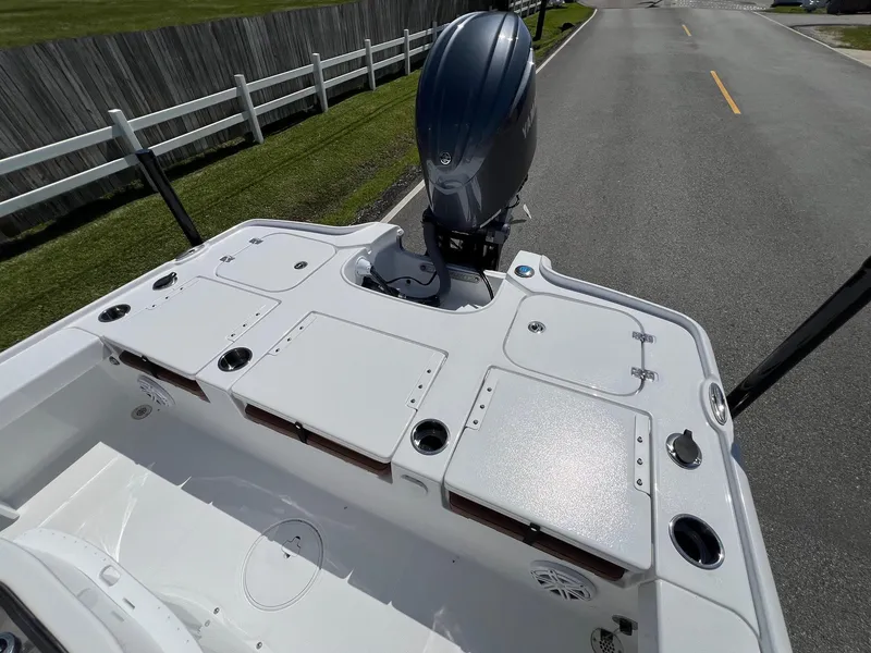 Slide: The Image of 2025 Sea Hunt BX22BR boat with outboard motor on a road, showcasing deck layout. - 8