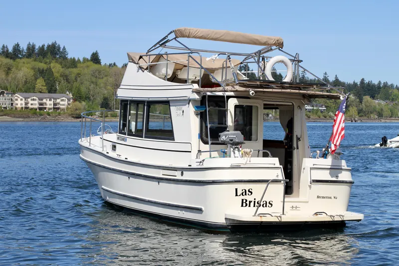 Slide: The Image of 1995 Camano Troll boat "Las Brisas" on a scenic lake with American flag. - 1