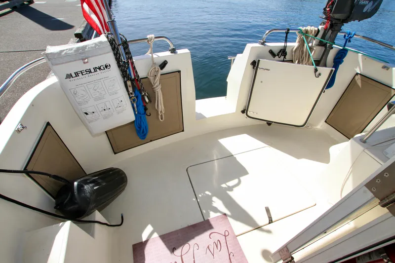 Slide: The Image of 1995 Camano Troll boat deck with lifesaving equipment and open storage compartments. - 18