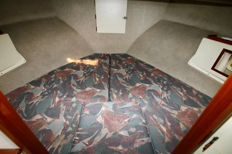 Slide: The Image of 1995 Camano Troll boat interior with patterned cushions and storage compartments. - 34