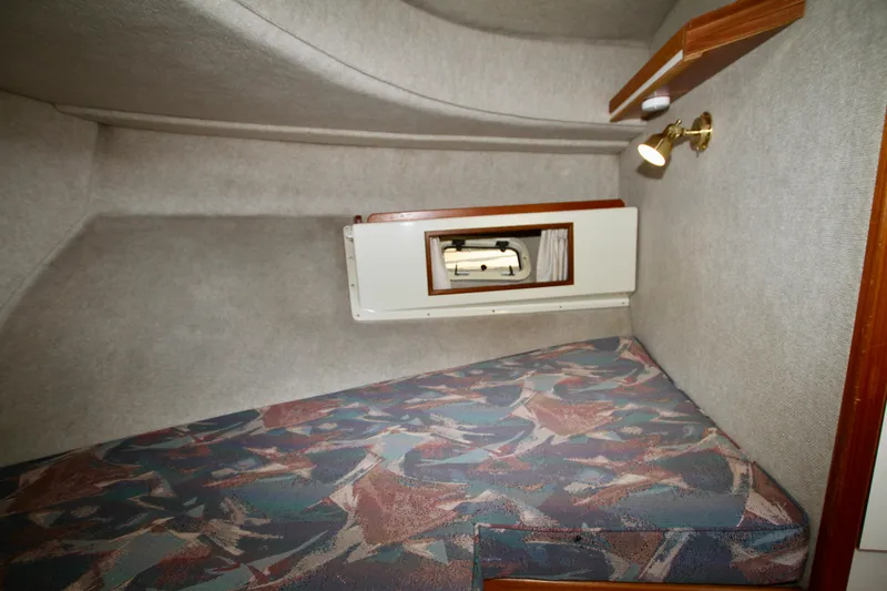 Slide: The Image of 1995 Camano Troll cabin interior with patterned upholstery and wall-mounted light. - 36