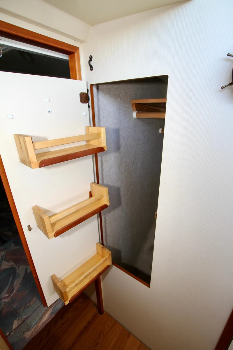 Slide: The Image of Interior of 1995 Camano Troll boat with wooden shelves and storage space. - 38