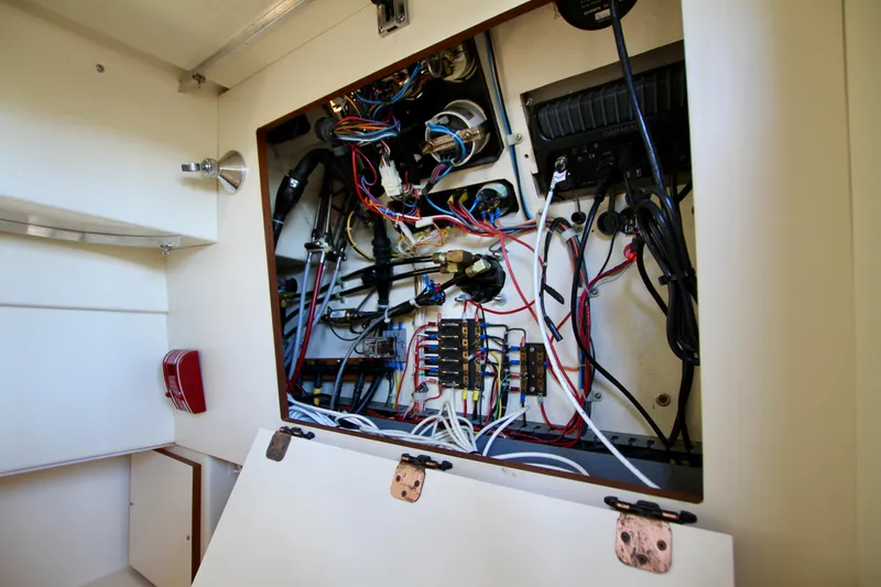 Slide: The Image of Electrical panel inside a 1995 Camano Troll boat, showcasing wiring and components. - 42