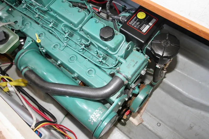 Slide: The Image of Engine of a 1995 Camano Troll boat, featuring a green Volvo Penta motor. - 43