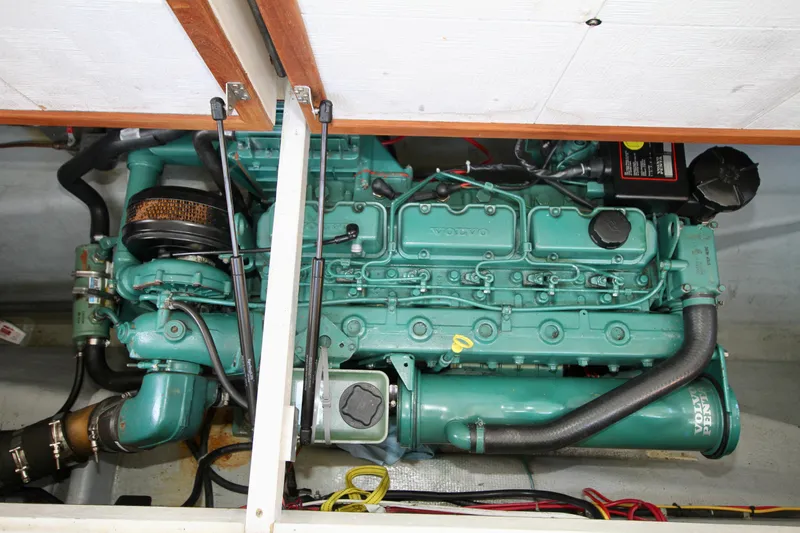 Slide: The Image of Engine compartment of a 1995 Camano Troll boat, showcasing a well-maintained marine engine. - 45