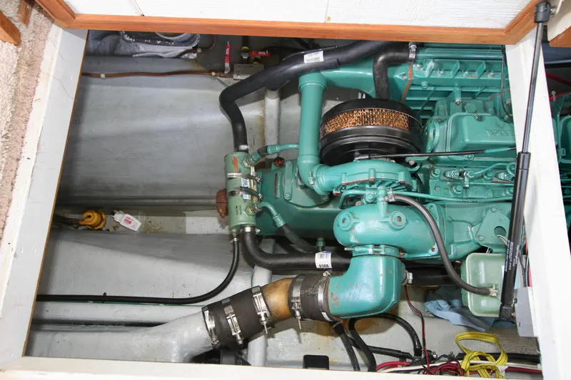 Slide: The Image of Engine compartment of a 1995 Camano Troll boat, showcasing mechanical components and wiring. - 46