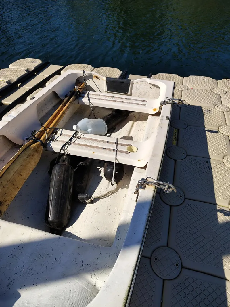 Slide: The Image of 1995 Camano Troll boat docked with oars and equipment on board. - 48